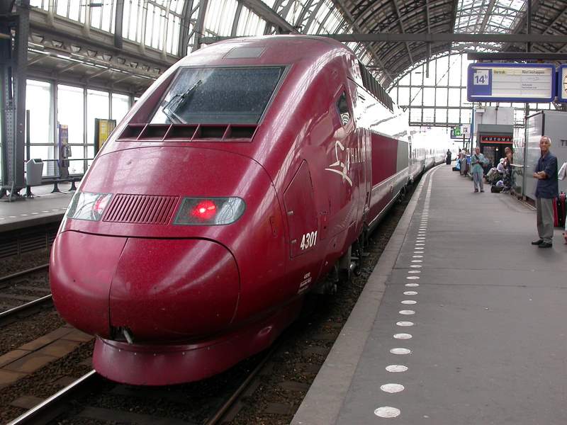 a large red train is sitting at a station