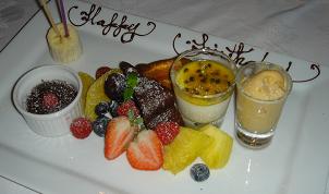 a white plate with fruit on it and dessert