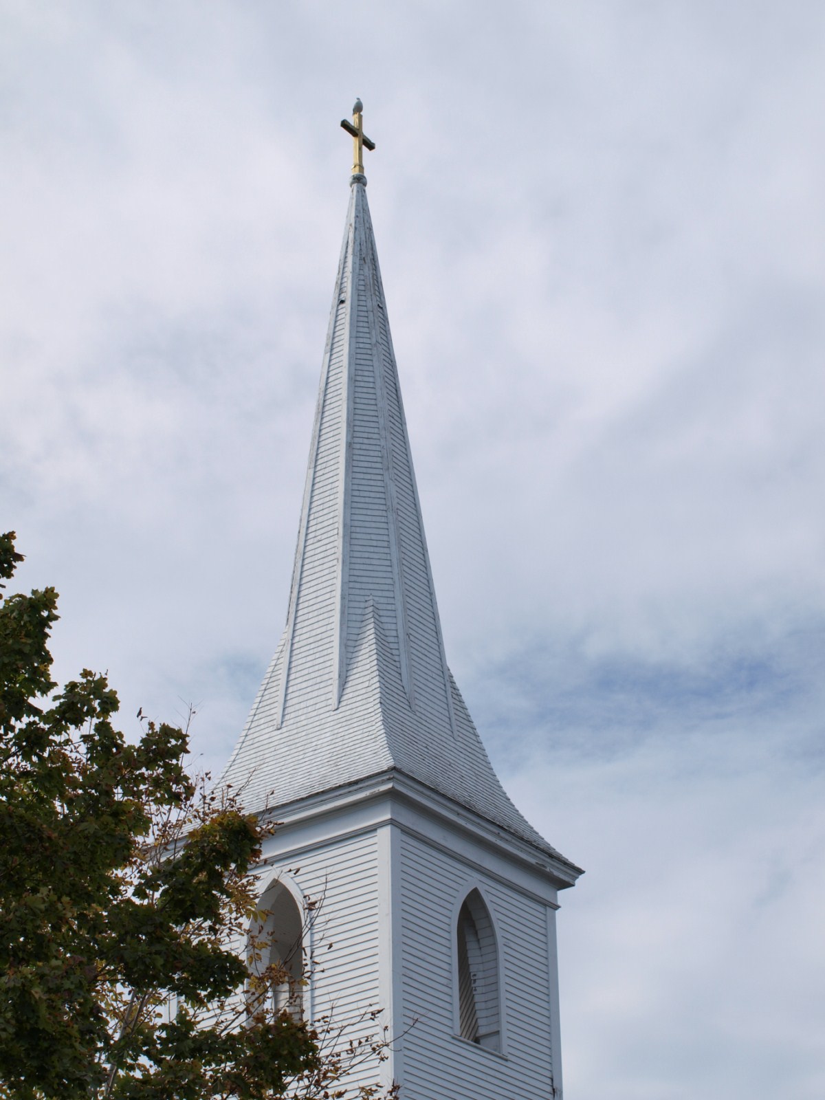 there is a church steeple with a cross on top