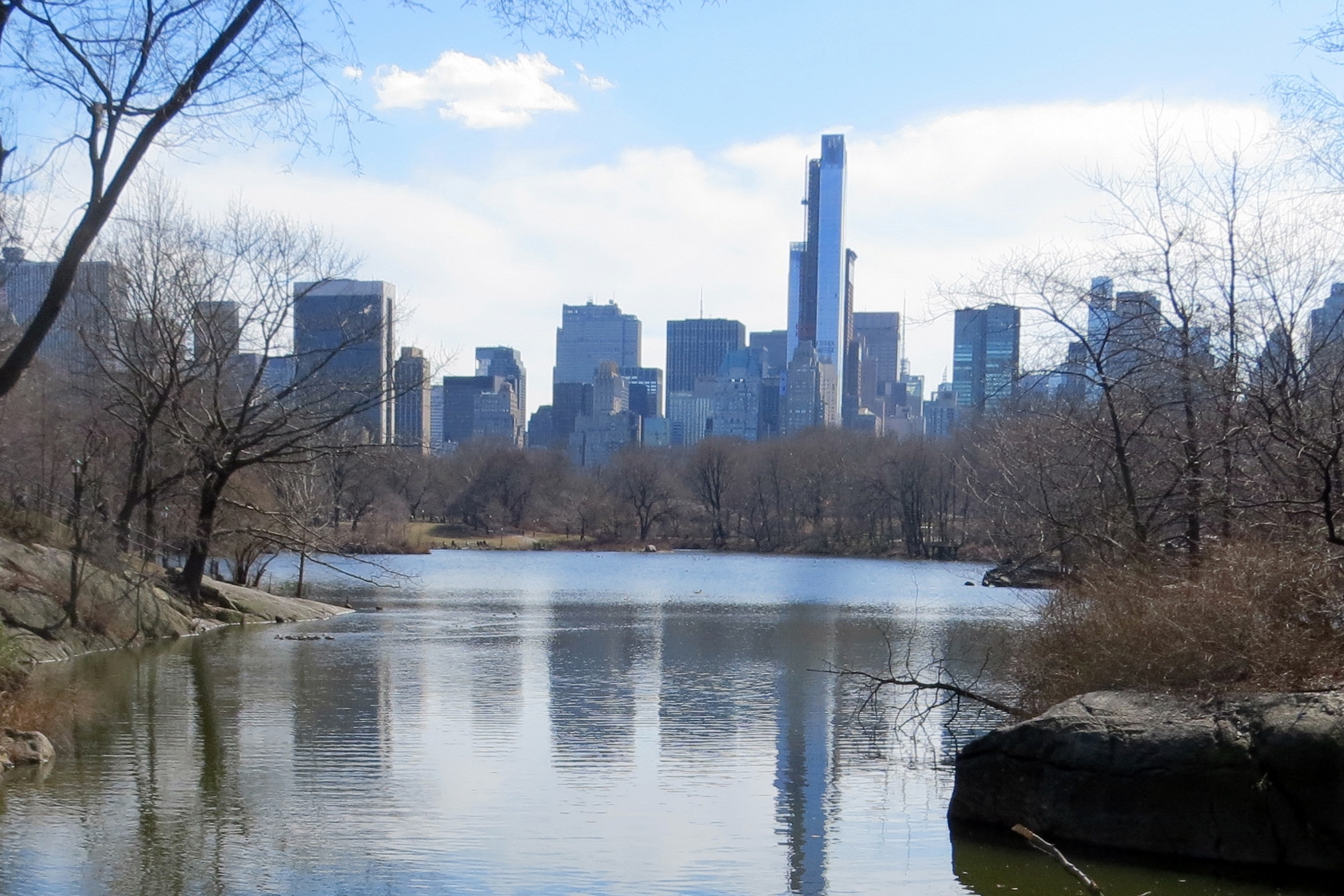 a large lake next to a city in the day