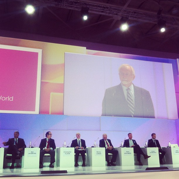 the panel of executives on a large stage