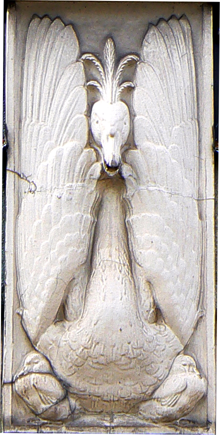 a stone relief of a dove in an elaborate manner