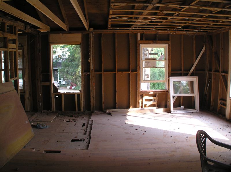 a room being renovated with unfinished wood framing and windows