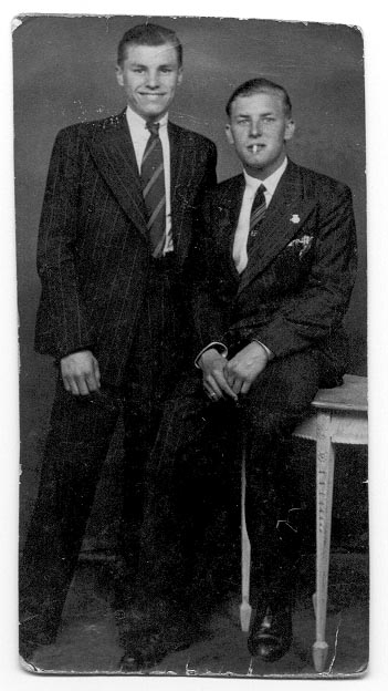 two men in suits posing for a po
