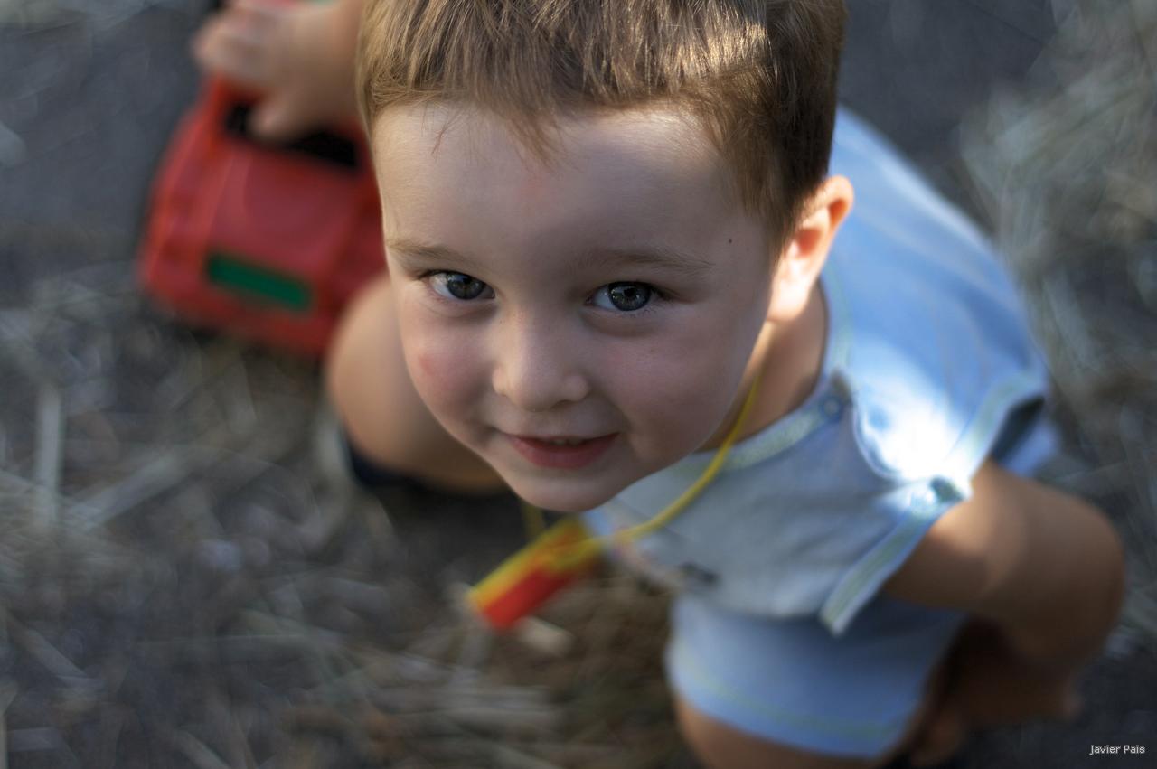 a child in a field with a toy