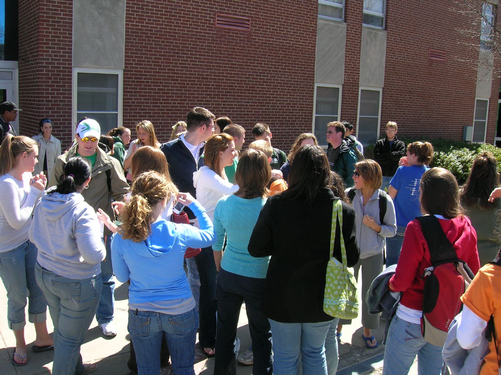 a large crowd of people standing in a courtyard