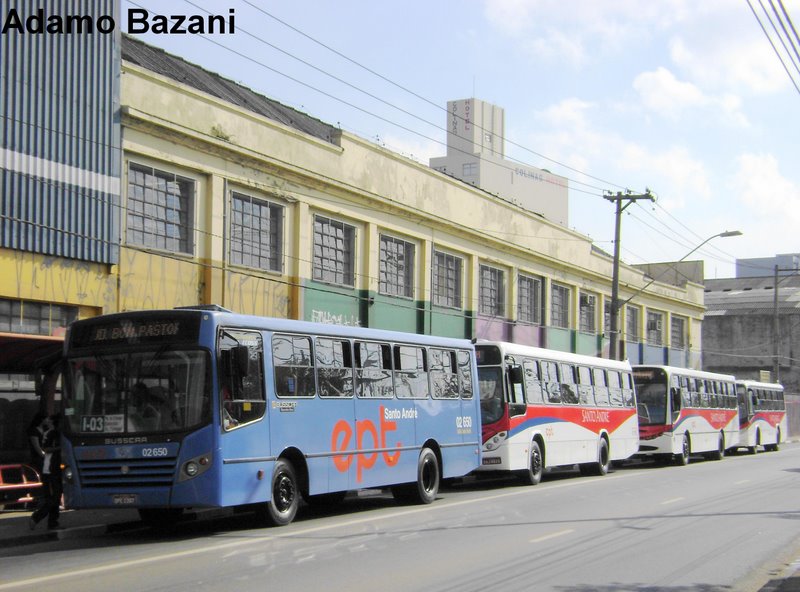 a couple of public transit buses parked outside a building