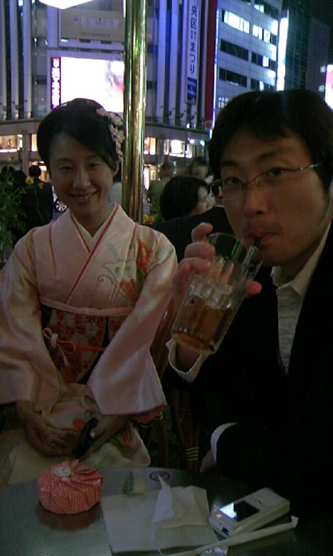 a man and woman drinking beverage at a table
