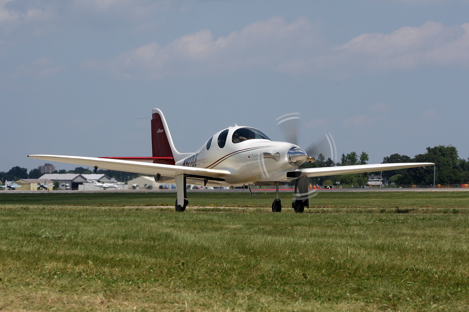 a small propeller airplane on a grassy field