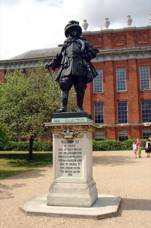 a statue of an old man in front of a building