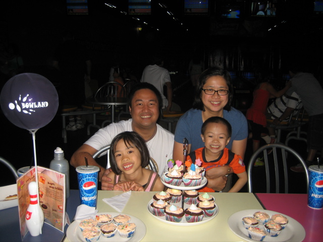 a family is sitting around a table at night time