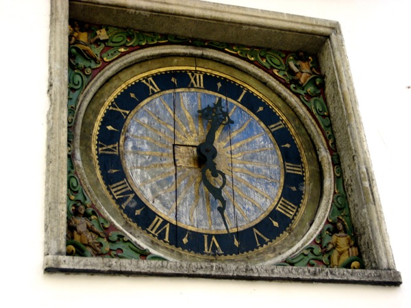 a fancy clock that is on the side of a building