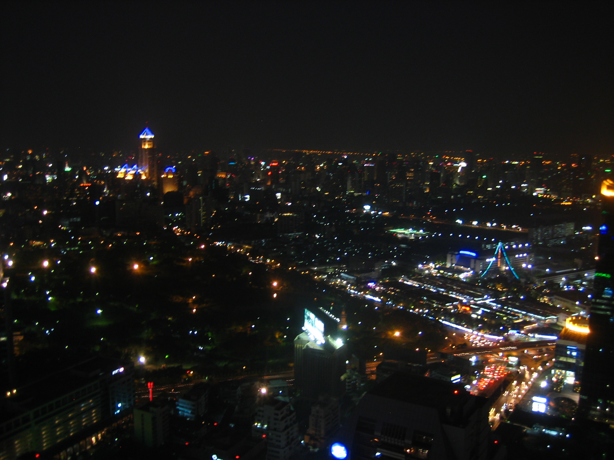 a city at night with bright lights and street lamps