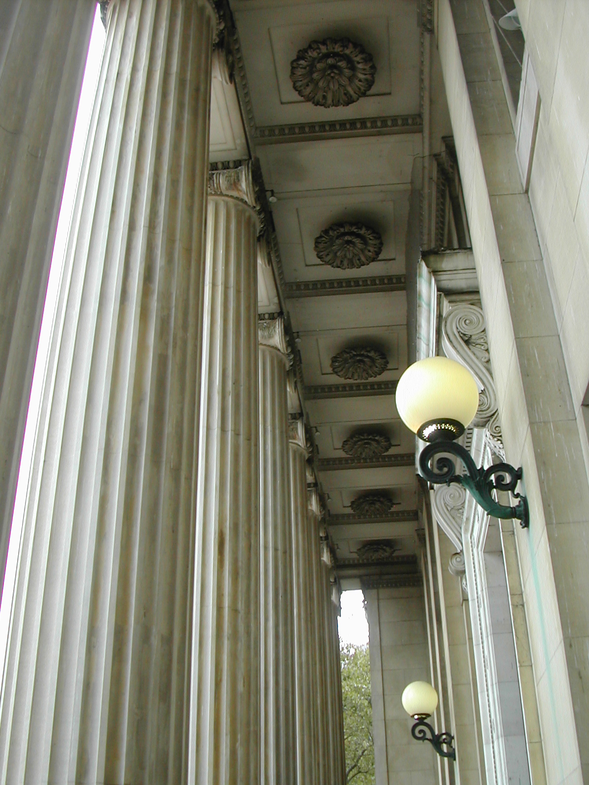 a lamp is in between two tall columns