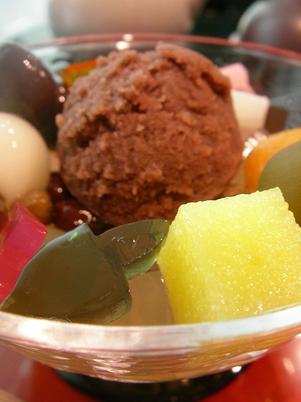 a bowl of fruit and ice cream on a table