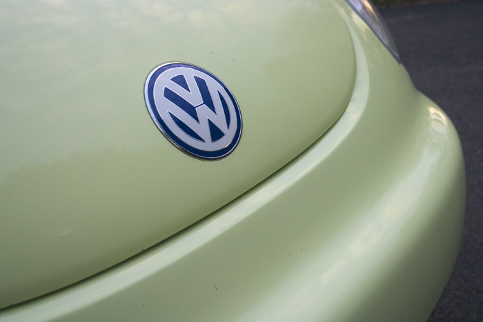 the emblem of a volkswagen car on a green car