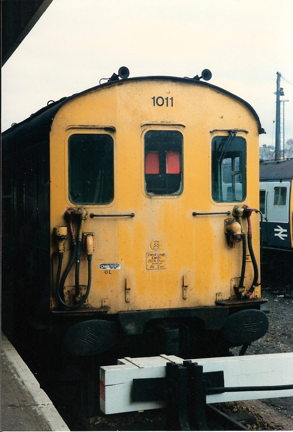 a yellow train is sitting at a station