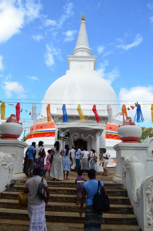 people gathered outside an ornately decorated white temple