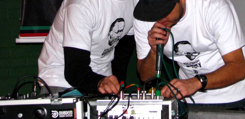 two men in t - shirts and hats operating wires
