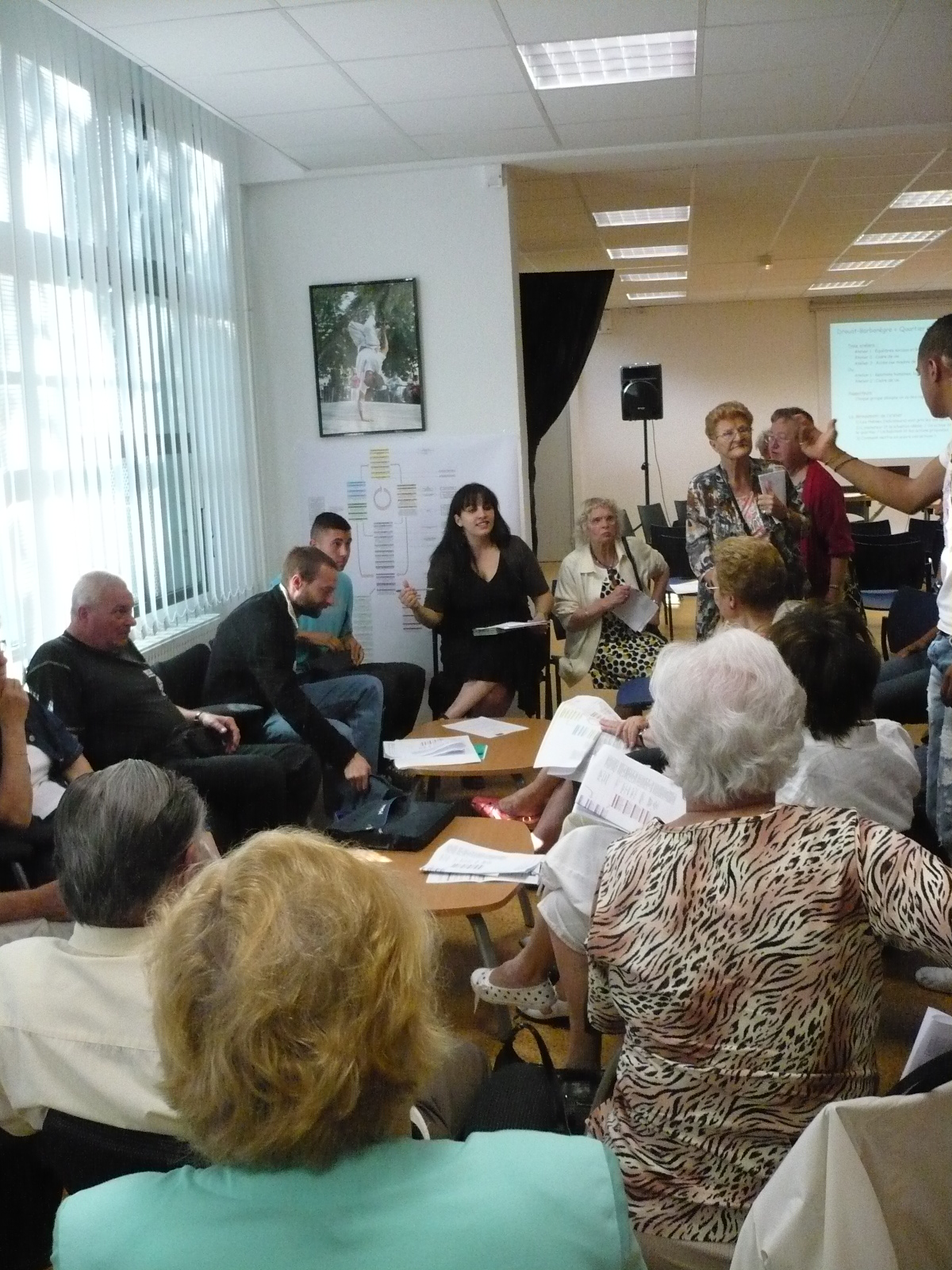 a group of people sitting in chairs looking around