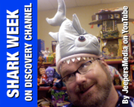 a man with glasses and a shark hat on