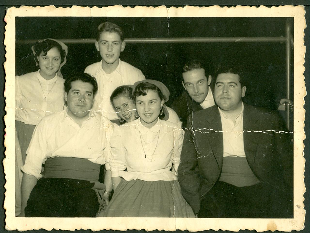 black and white pograph of seven people with three of them sitting on the side