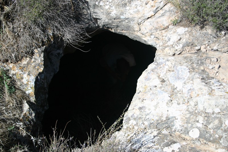 a cave is carved into the side of the hill