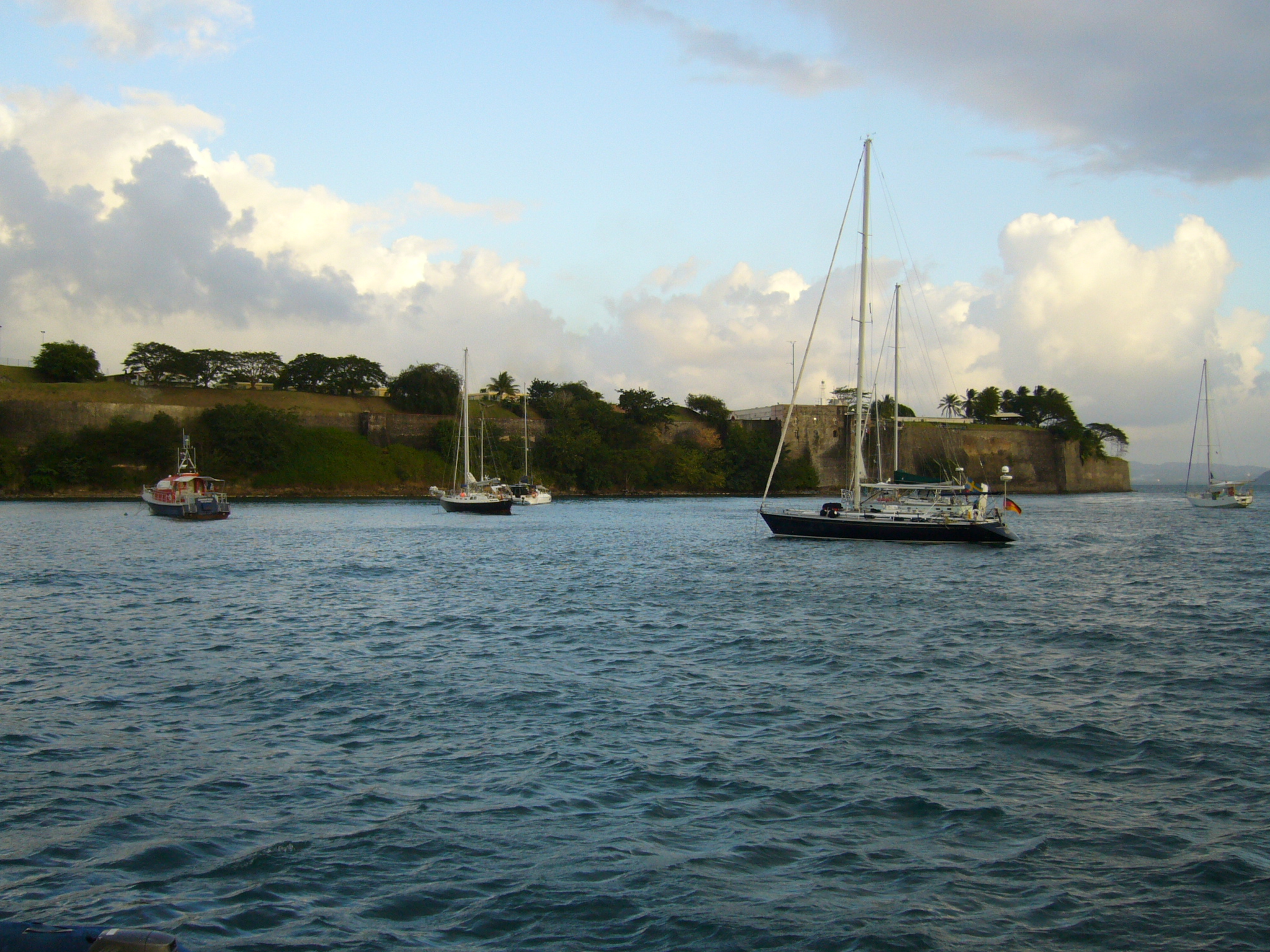 a group of boats sailing down a body of water