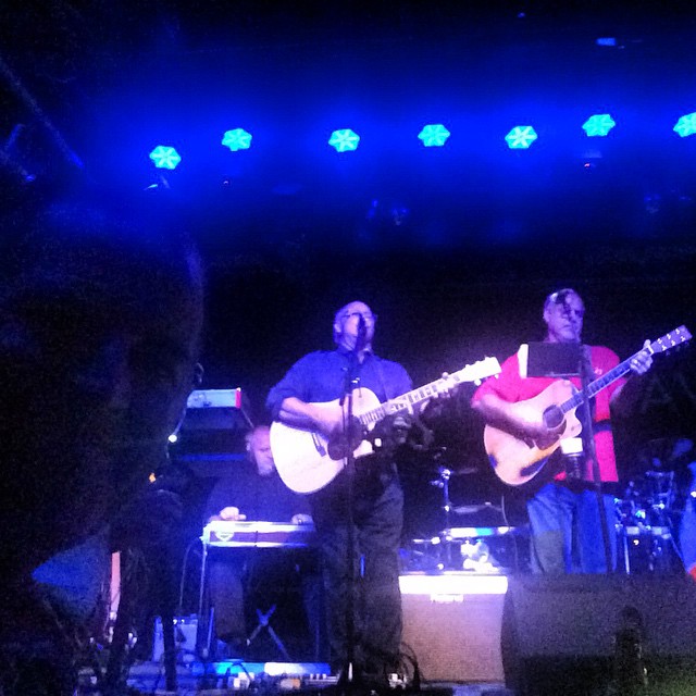 a couple of men standing on top of a stage