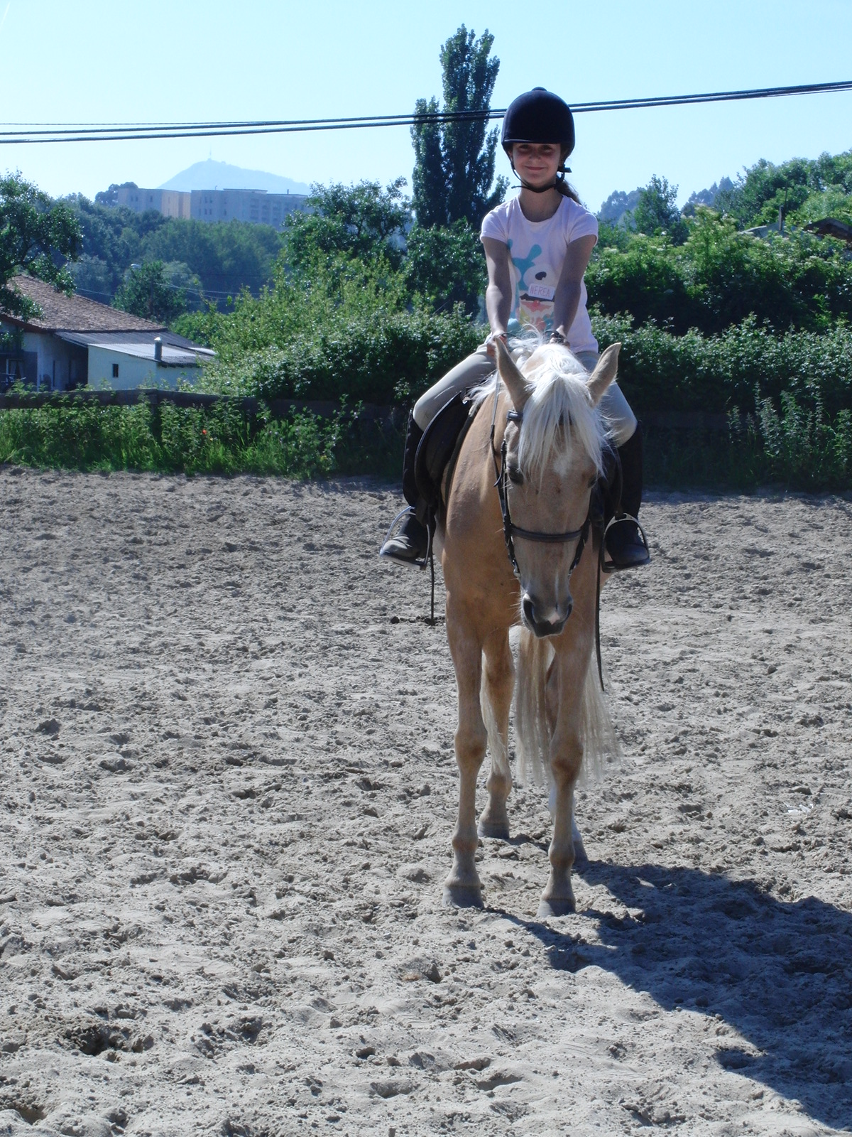 a  rides a horse through the dusty area