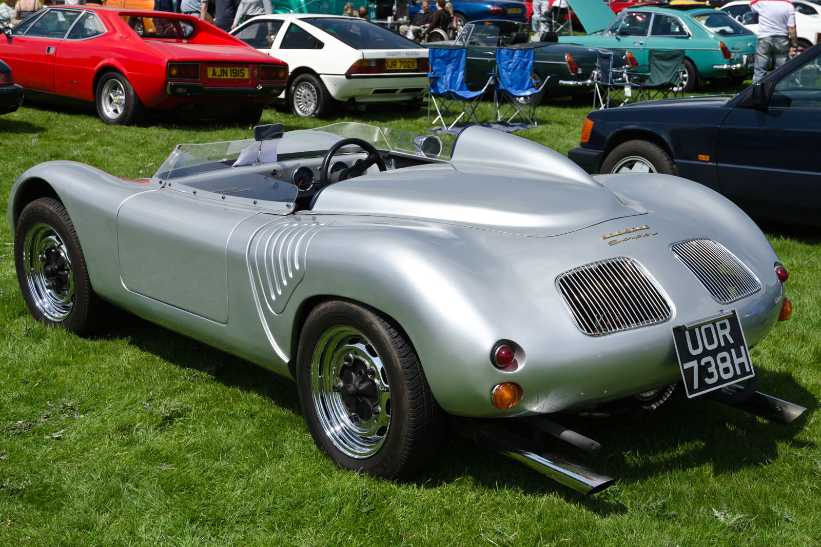 a silver car is on display at a car show