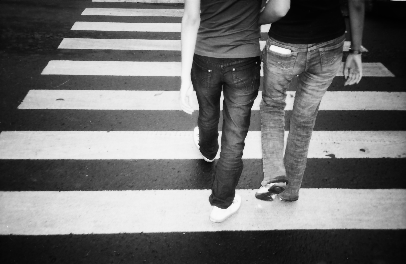 two people that are standing on the cross walk