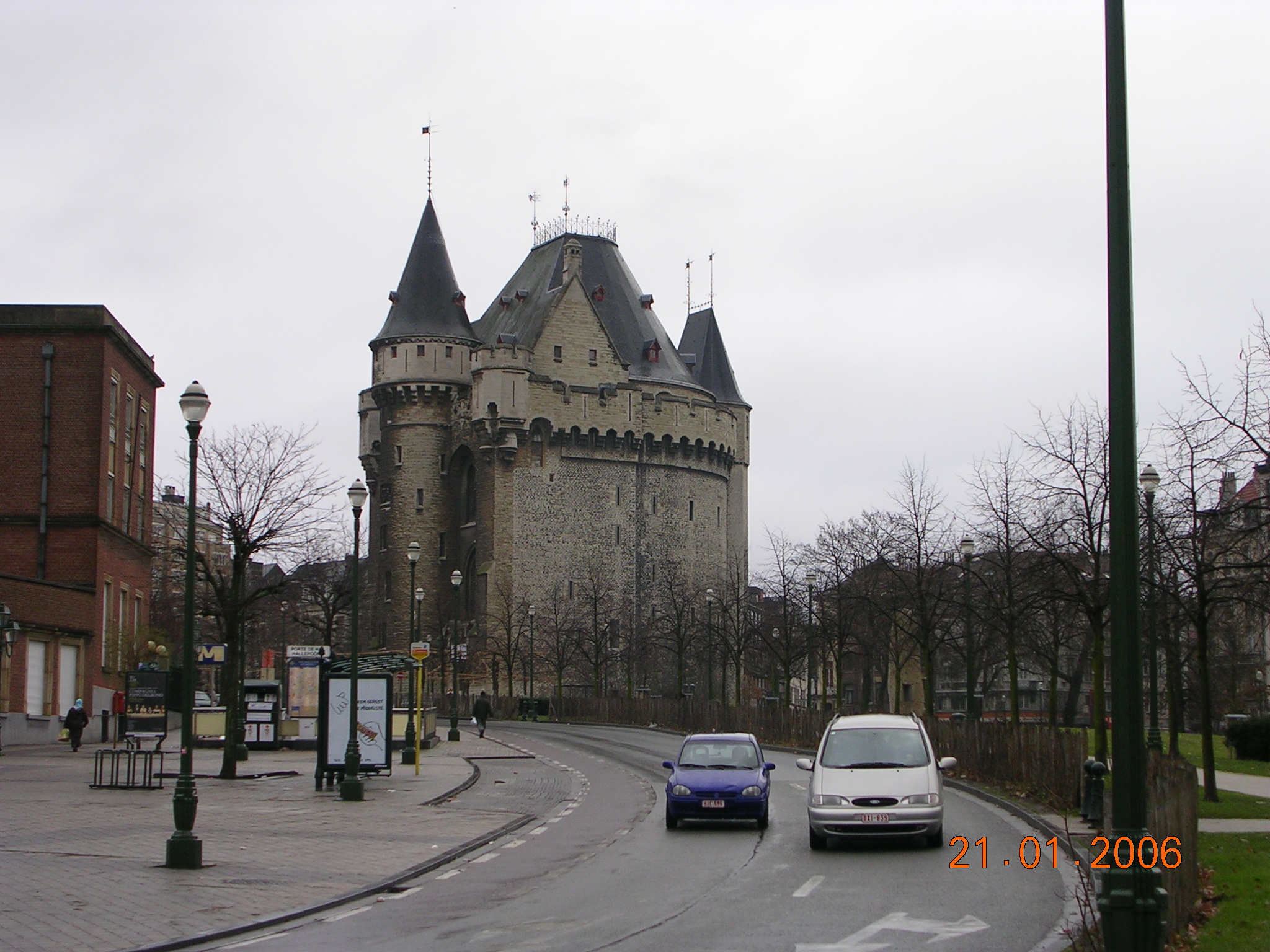 a car is driving by a castle on the street