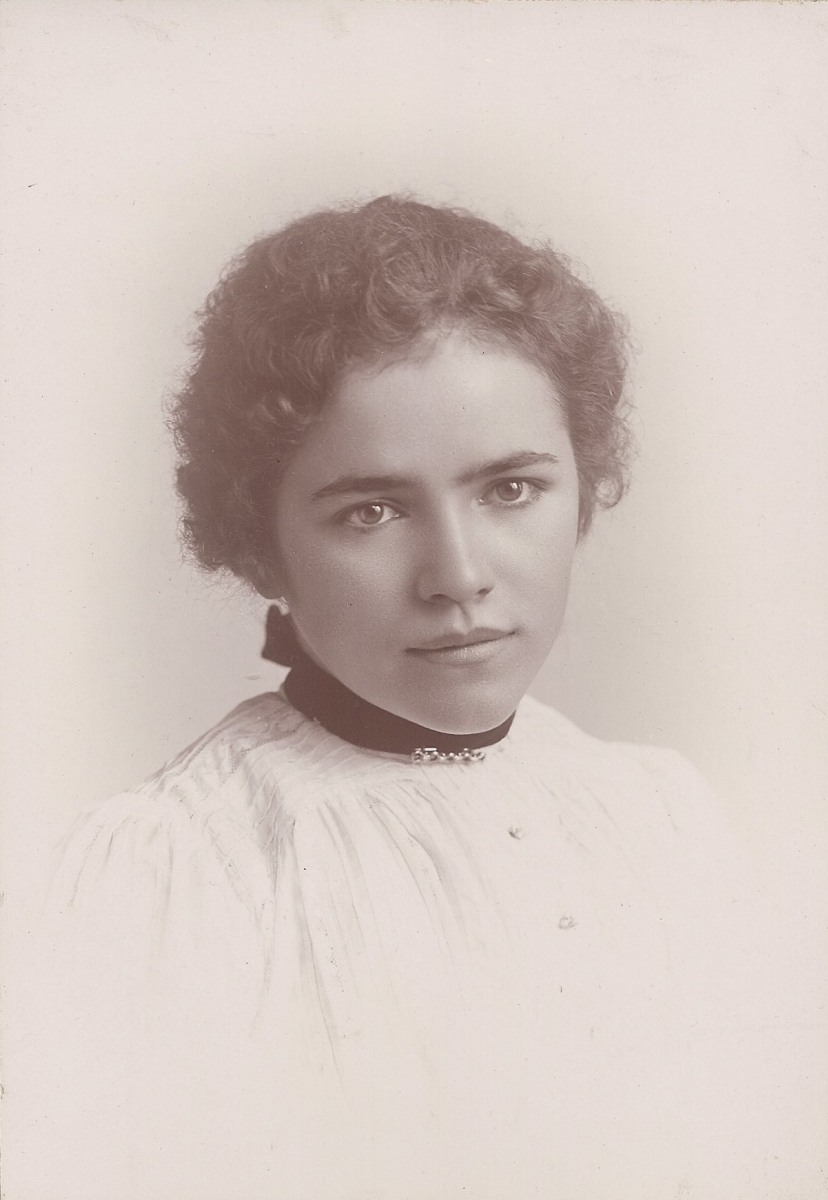 an old black and white pograph of a woman with short hair