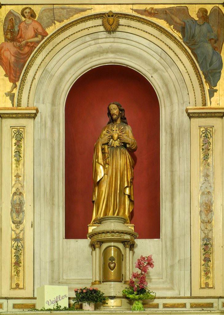 gold statue with angel on a large golden statue