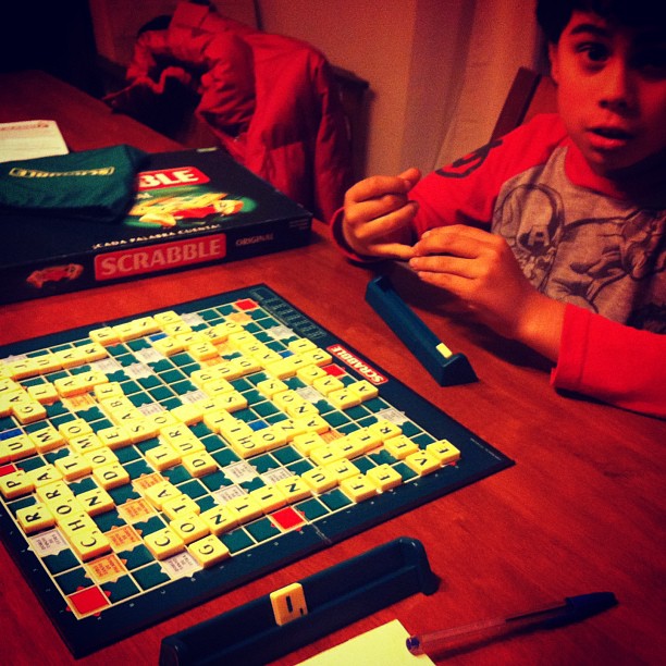a  is playing scrabble on the wooden table