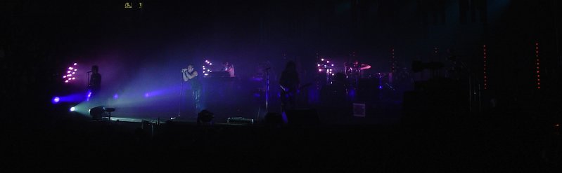 the crowd is watching colorful light show from a stage