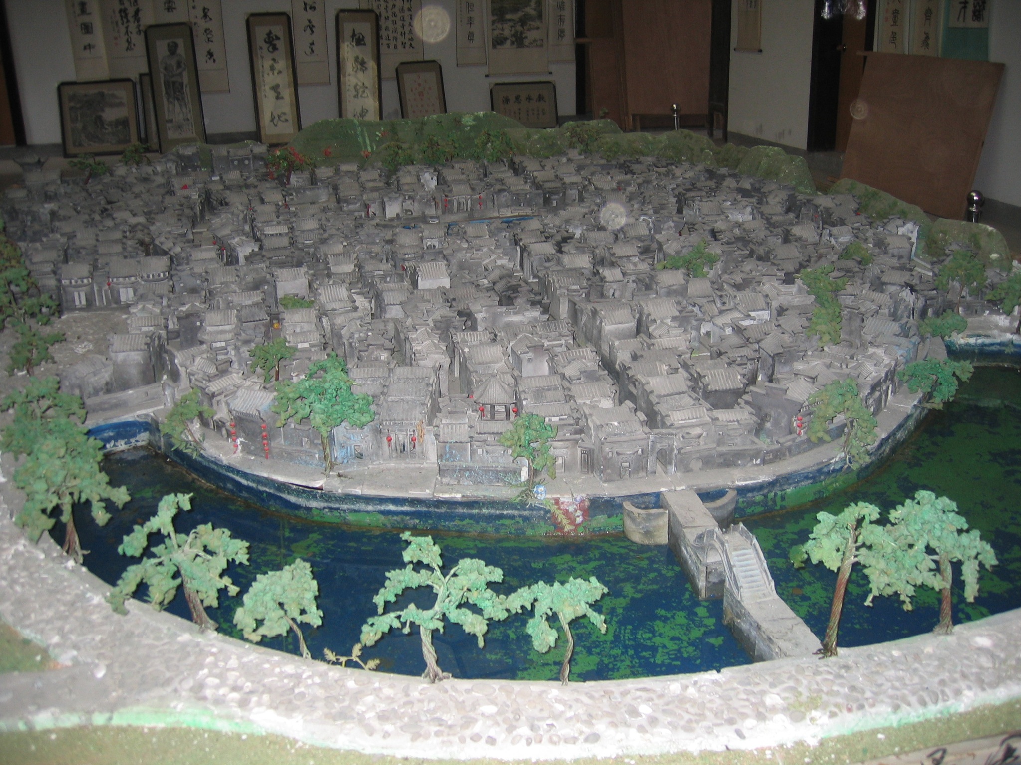 this model of the city is surrounded by other small buildings and trees