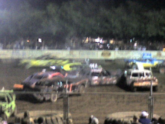 a dirt racing track during a night time event