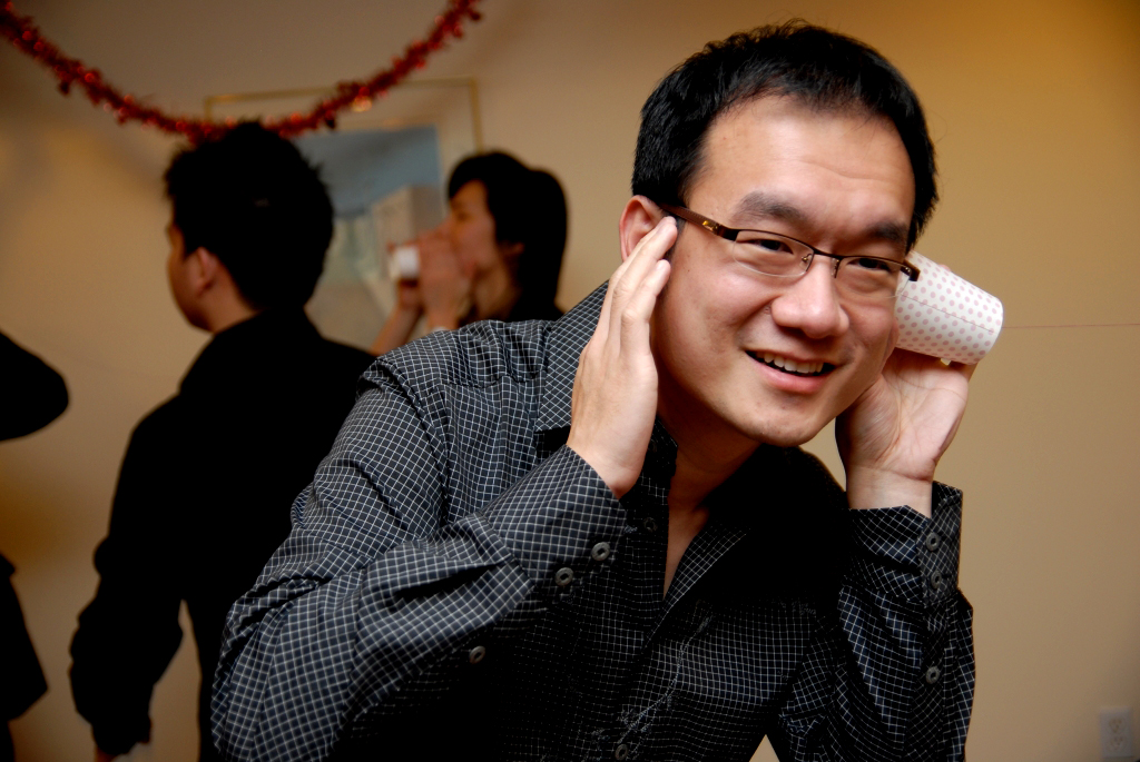 a man holding a white object to his head