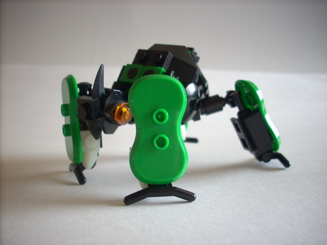 a lego robot holding a camera with it's arms
