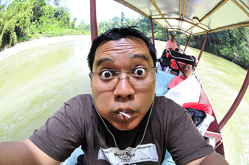 a man with an expression of surprised in the background on a boat