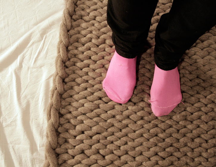 pink shoes are set up on a bed