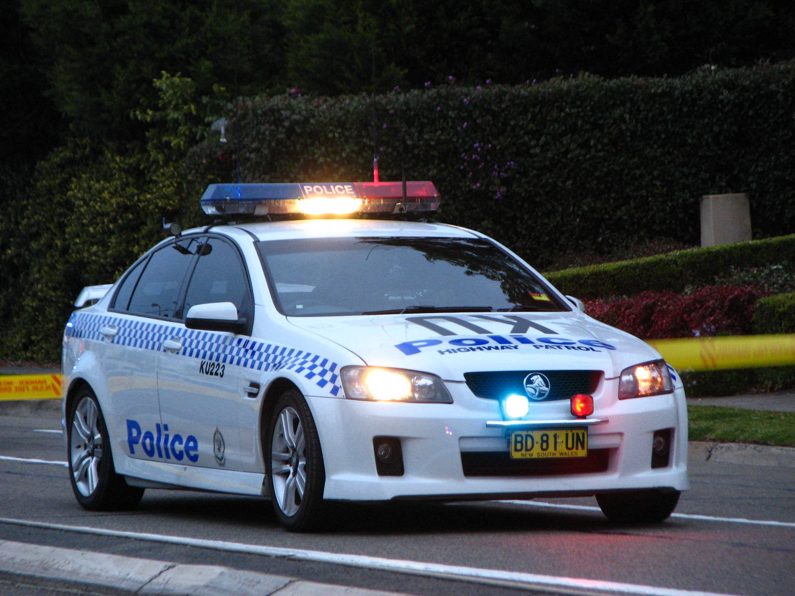 an police car stopped on the street at night