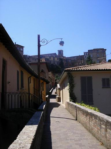 there is a long narrow alley way near the buildings