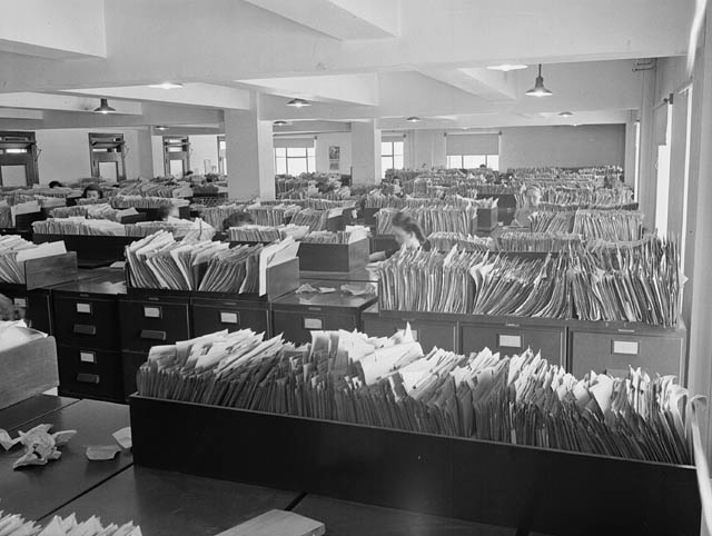 a room full of a bunch of documents in the middle of a pile