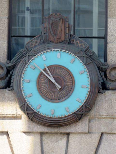 clock on the corner of the building has an ancient look