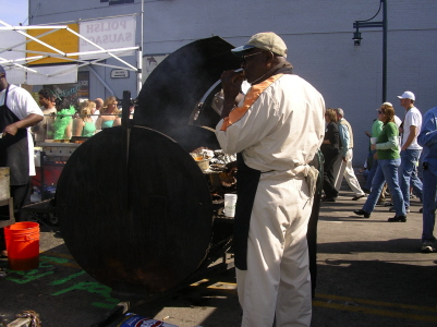 an image of a man holding a big grill in the middle of a street