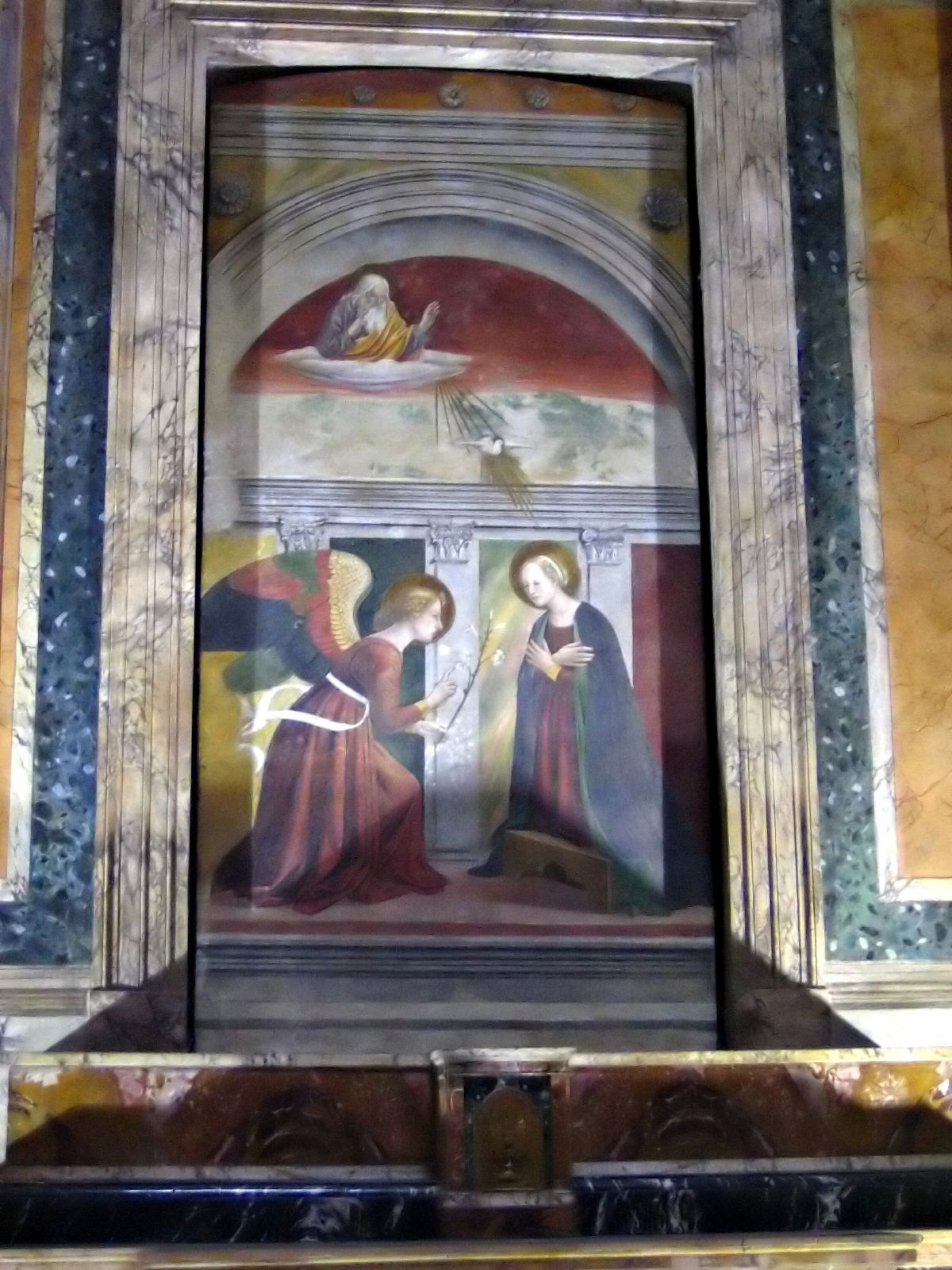 a religious scene with a painting on the wall