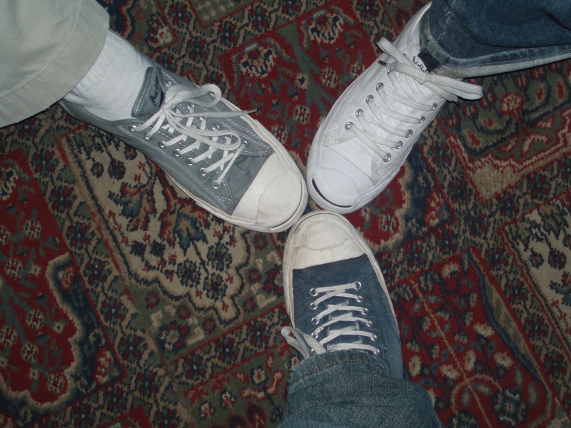 pair of shoes with socks around them sitting on carpet